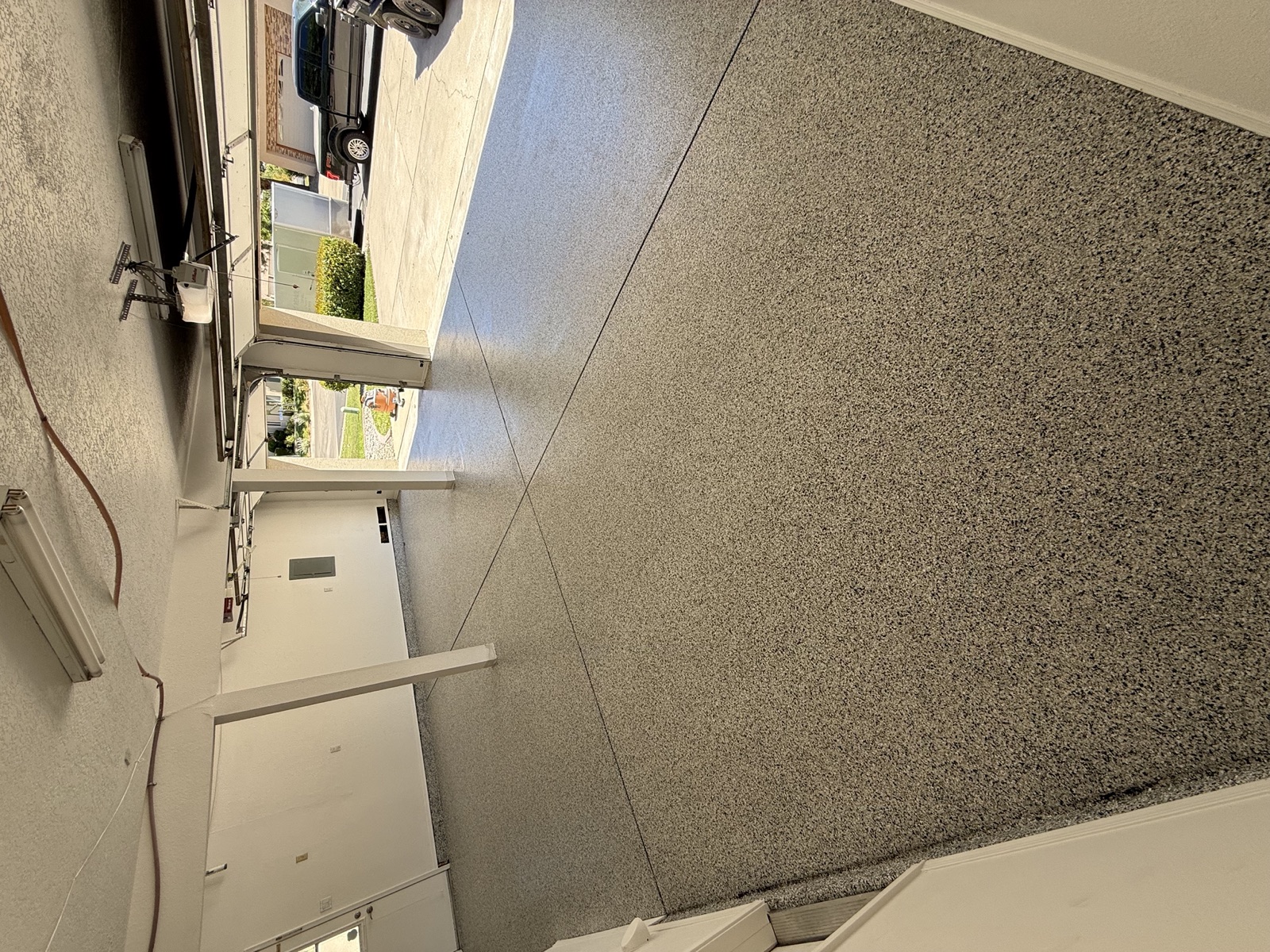 Residential 3 car garage metallic epoxy floor — angle view