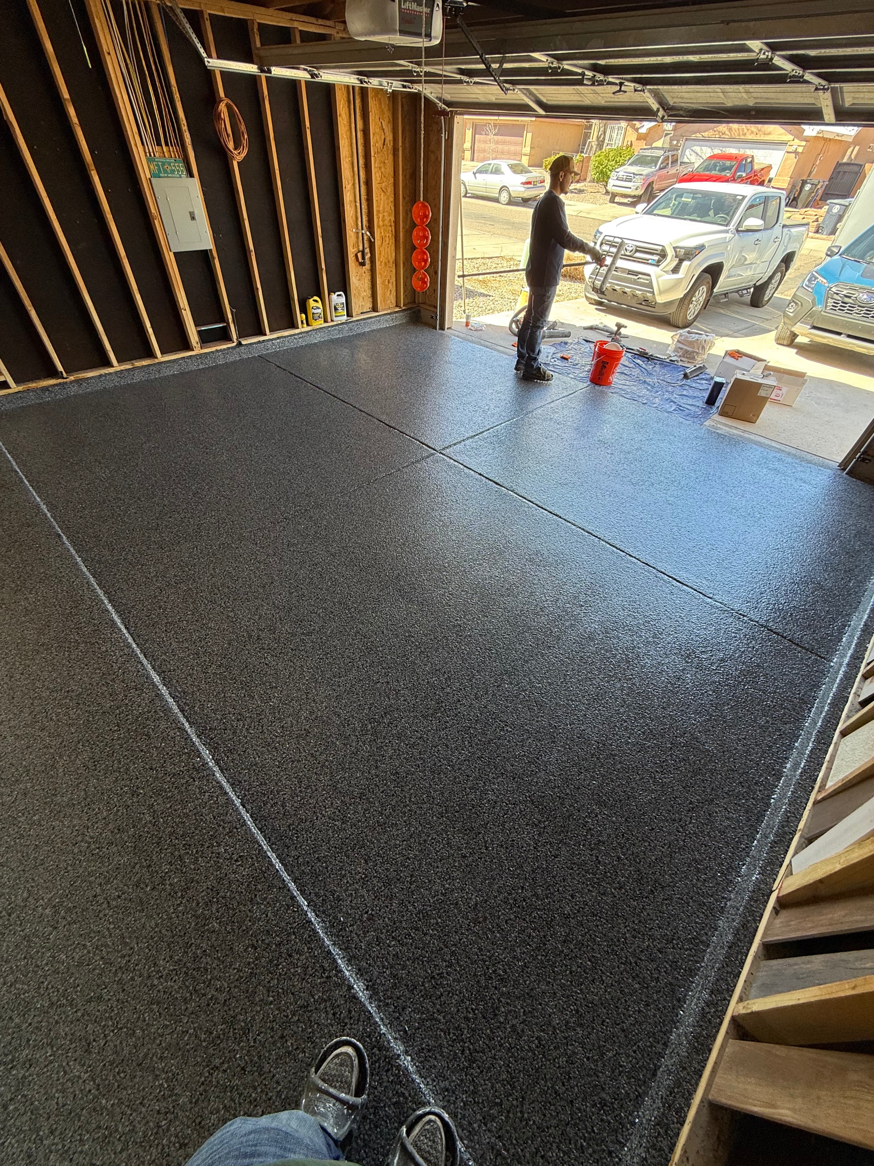Two-car garage with grey and white flake epoxy floor